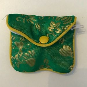 Small jewelry pouch with zipper and button closure